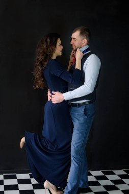 Güzel bir sevgi dolu çift siyah arka plan üzerine evde oturma odasında. Gençlik iki aşık