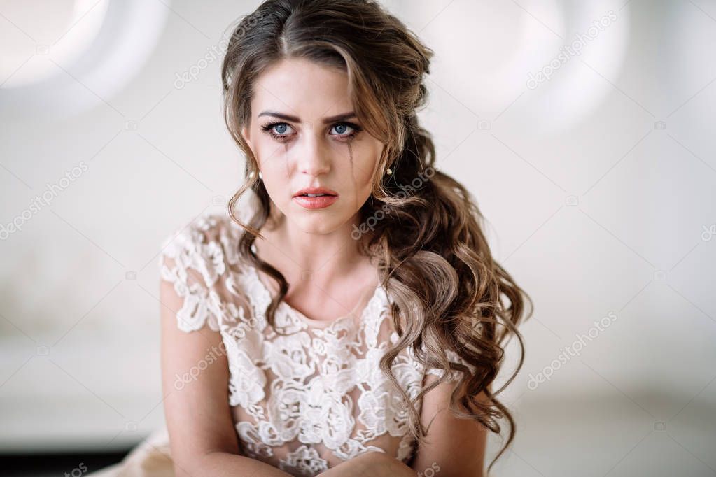 portrait of the bride crying, sadness, streaks mascara wipes.