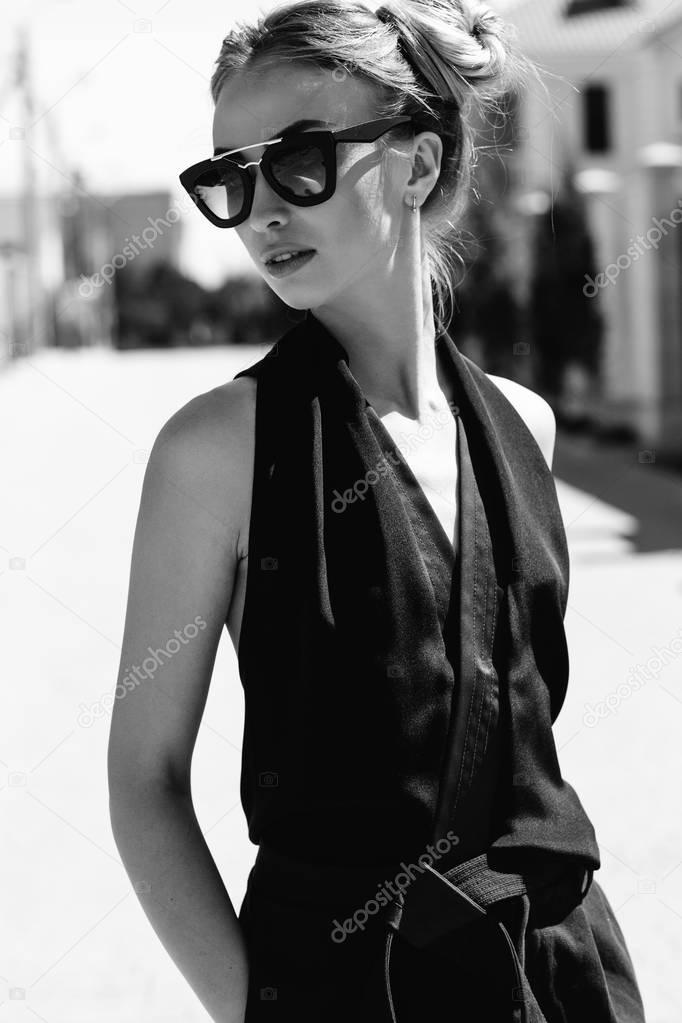 Portrait of a beautiful woman smiling pretty happy smiling, wearing sunglasses. Fashion style
