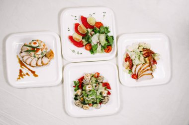 Beyaz masa örtüsü, aperatifler tarafından çevrili. Çeşitli yemekler. Mutfak, menü, gıda kavramı