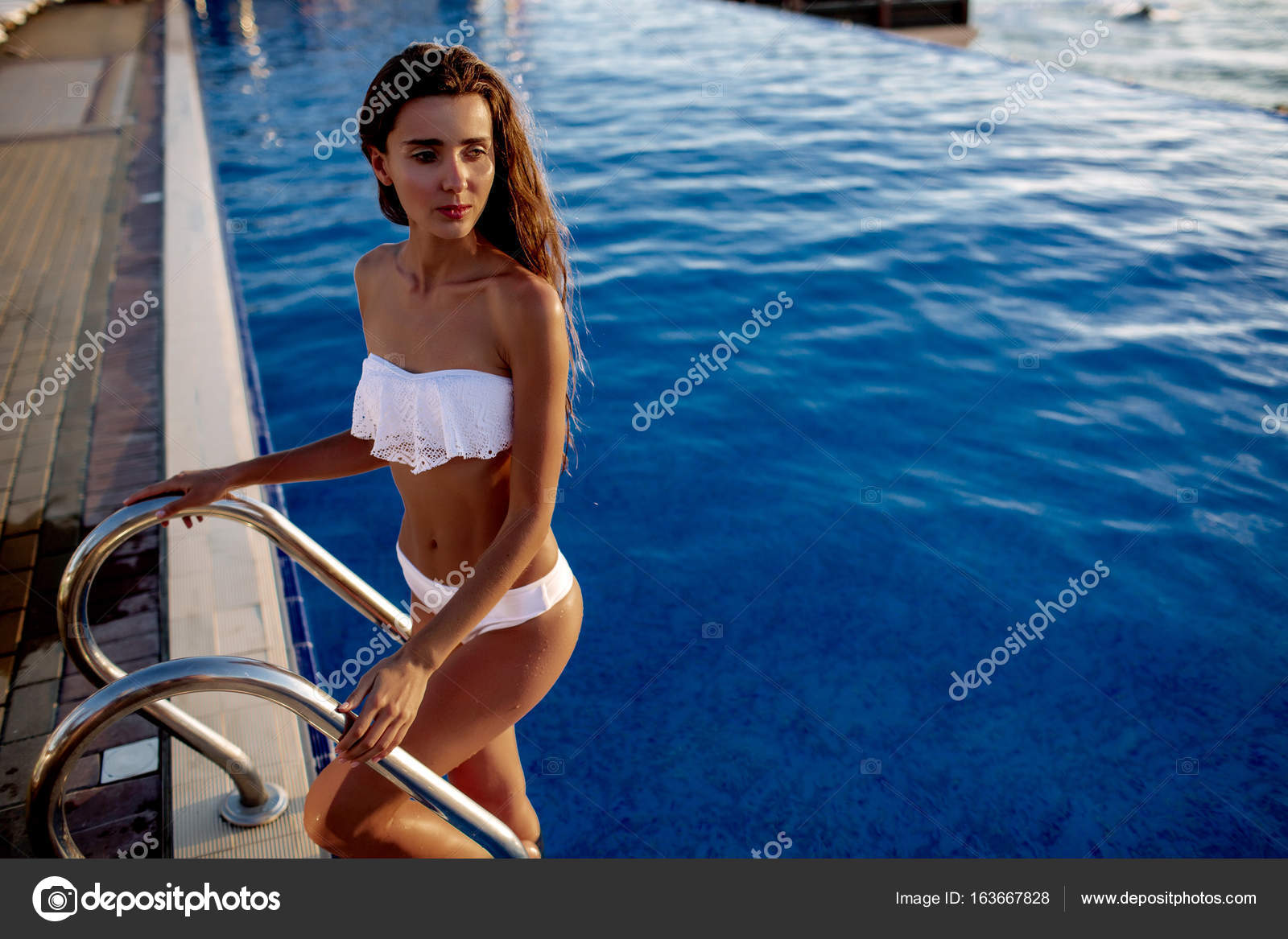 Beautiful Brunette Girl In Good Shape With Long Blonde Hair And A