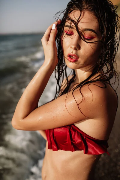 Sexy girl of Asian appearance in her swimsuit on the sea with sand, fashion — Stock Photo, Image