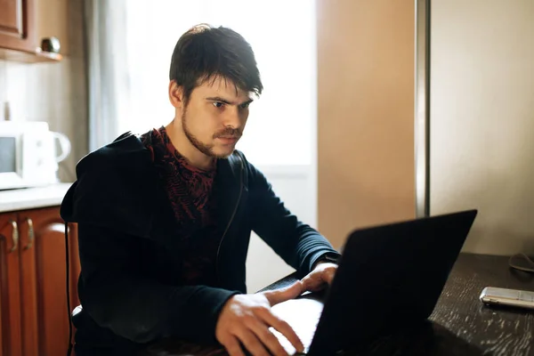 Young Bearded Hipster Man Dressed Black Jacket Sits Home Kitchen — Stock Photo, Image