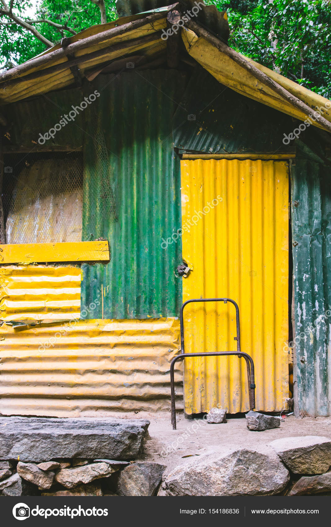 A Shed Or S Made Of Corrugated Iron Painted Green And