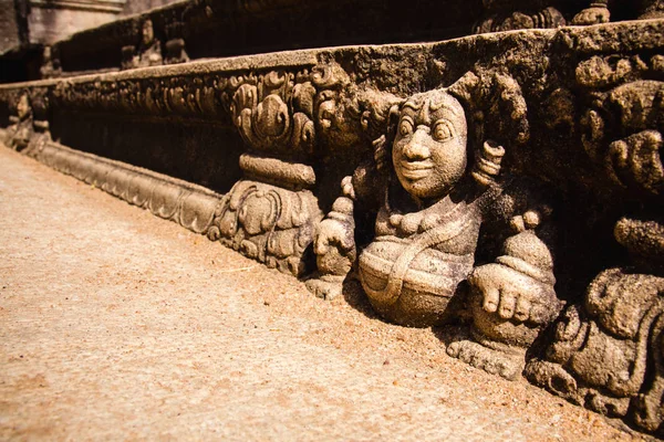 Stairs of a ruined palace decorated with reliefs of dwarves in a — Stock Photo, Image