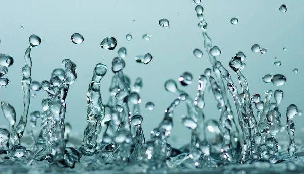 Water splash on blue background Royalty Free Stock Photos