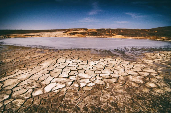 Dramatic sky with clouds over cracked earth — Stock Photo, Image