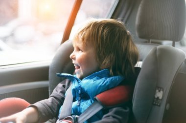 Araba koltuğuna oturan güzel yürümeye başlayan çocuk portresi. Çocuk ulaşım güvenliği