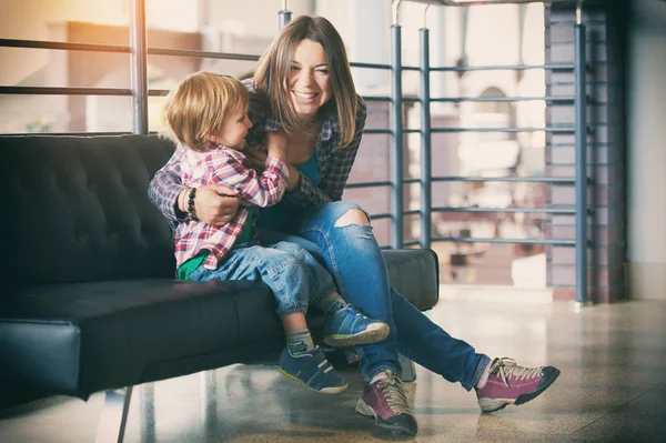 Beautiful mother sitting with her cute son — Stock Photo, Image