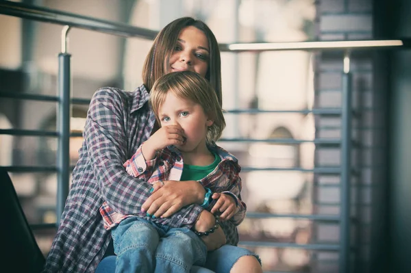 Beautiful mother sitting with her cute son — Stock Photo, Image