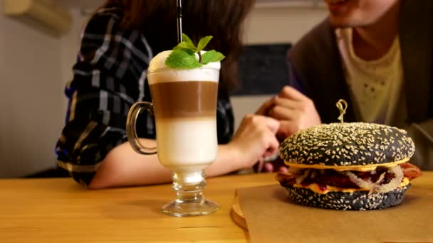 Cerrar hamburguesa y café en la mesa — Vídeos de Stock