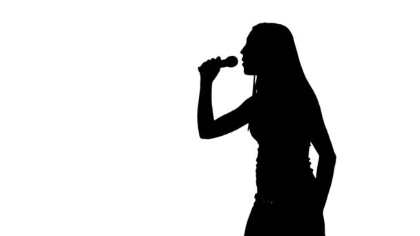 Female sings into the microphone silhouette — Stock Video