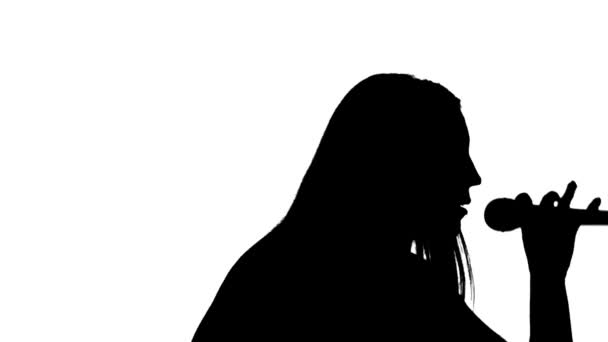 Girl and sings in a microphone silhouette — Stock Video