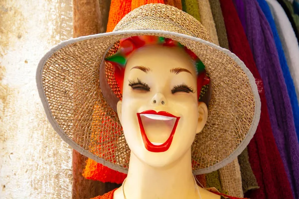 Funny cheerful mannequin head wearing hat in store Stock Image