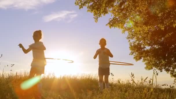 Duas crianças meninas brincam com hula-hoop — Vídeo de Stock