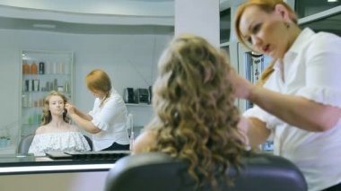 Sarışın uzun curl saç ve mavi gözleri modeli cilt için ton krem uygulayarak profesyonel makyaj sanatçısı.