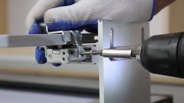 Mans hands tighten screw during assembling furniture doors system. Close up view. — 비디오