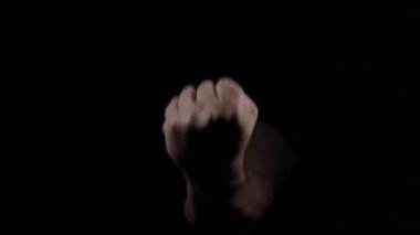 Caucasian male hand demonstrates aggressive warning fist