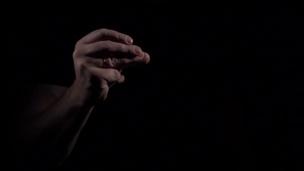 Mans hand shows finger multiple clapping gesture on black background. — Stock Video