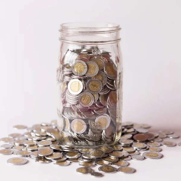 Savings glass jar with many mexican pesos — Stock Photo, Image