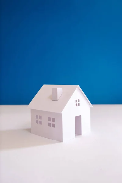 all white paper miniature house with blue color background