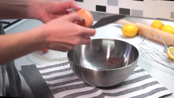 Female hands break the egg with a knife — Stock Video