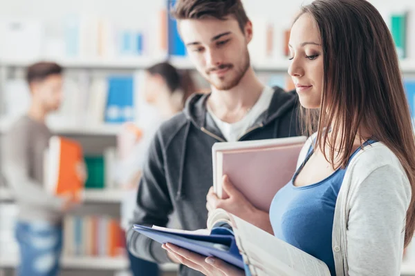Smiling students in school library — Stock Photo, Image