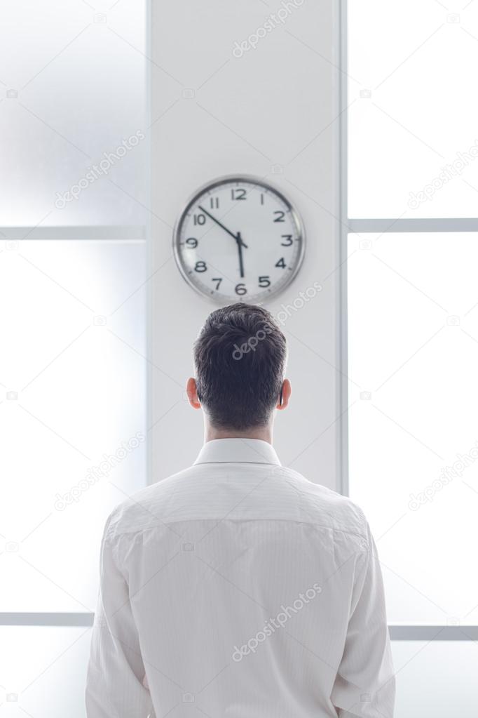 Businessman staring at the clock