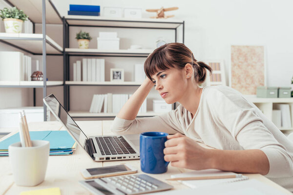 Tired woman at office desk