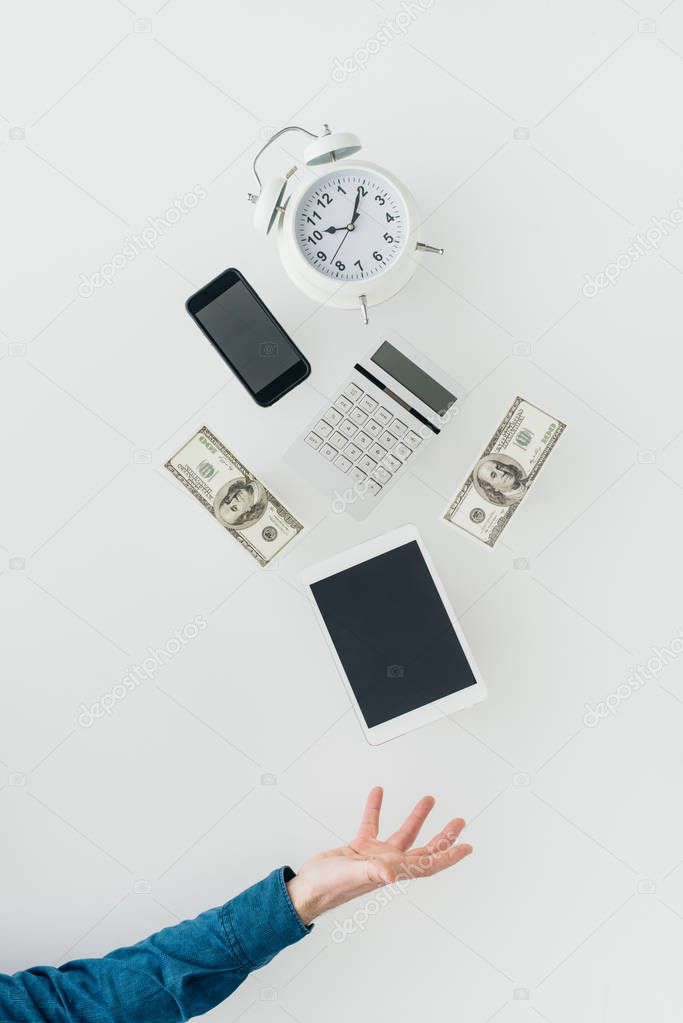Clock, calculator, cash dollars, tablet and smartphone