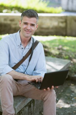 Dizüstü bilgisayarla çalışan adam