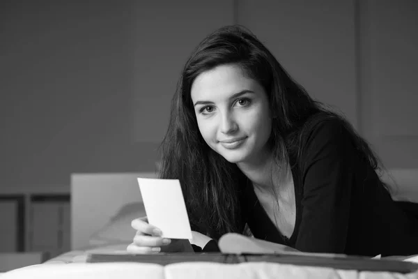 Young smiling woman relaxing on bed — Stock Photo, Image