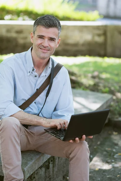 Dizüstü bilgisayarla çalışan adam