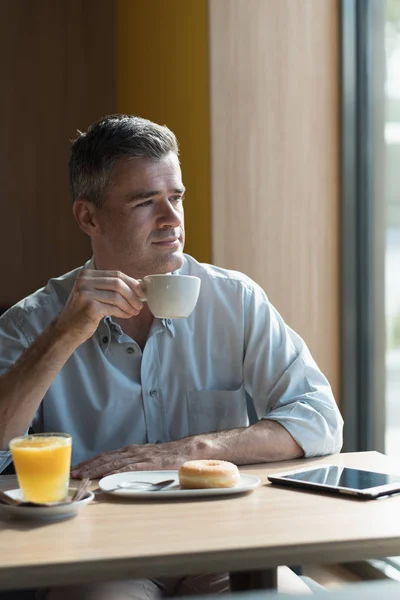 Businessman at bar having cup of coffee — Stock Photo, Image