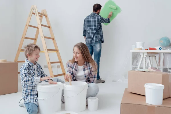 Young family  painting rooms