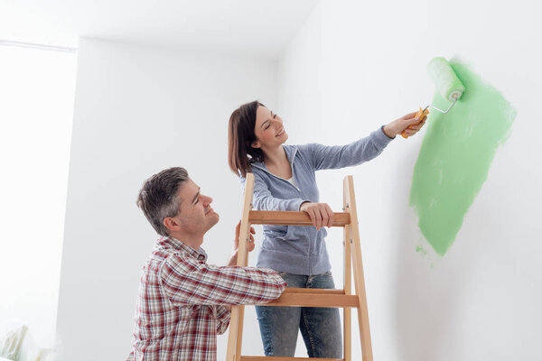 Couple painting walls 