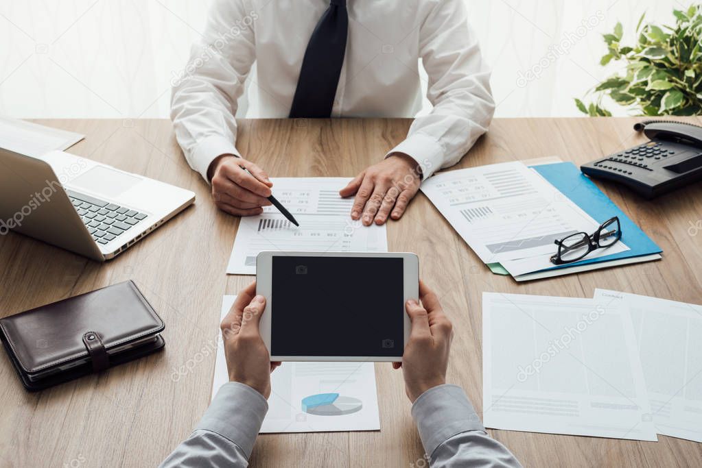 Business partners working at office desk