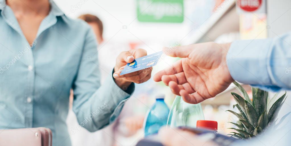 Woman at supermarket checkout