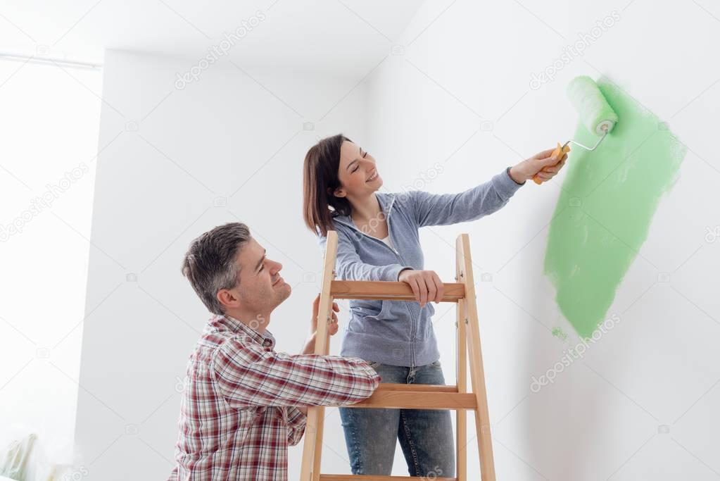 Couple painting walls 