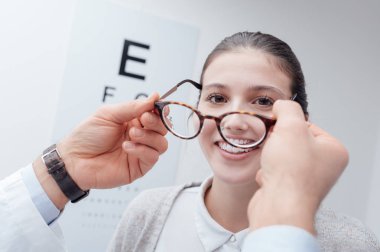 woman trying new glasses clipart