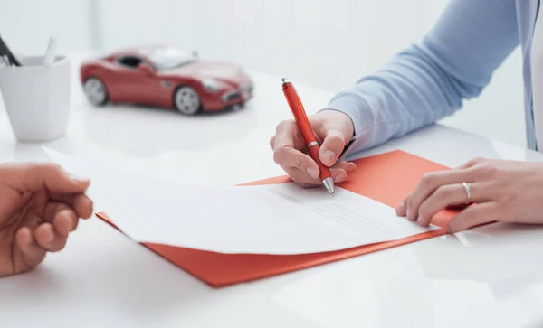 Femme signant une police d'assurance auto — Photo