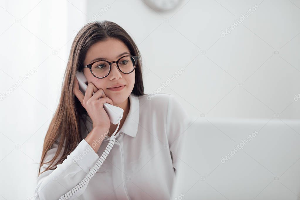 smiling secretary answering phone calls