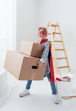 süper kahraman çocuk ağır kutularını taşıma