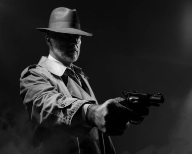 Spy agent pointing gun in dark  clipart