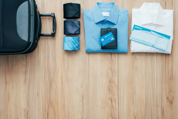 Bag with formal clothing and plane ticket — Stock Photo, Image