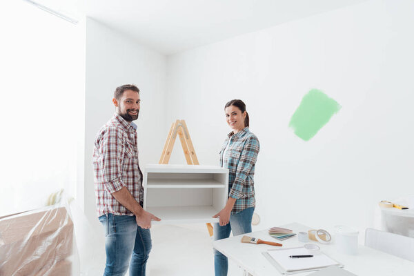 Couple moving furnishings together