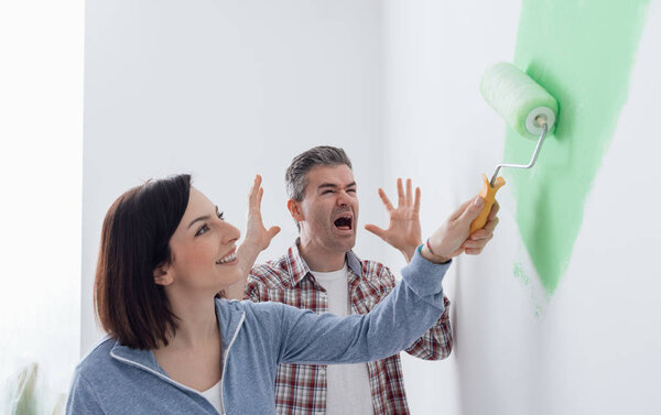 Woman painting room with bright green