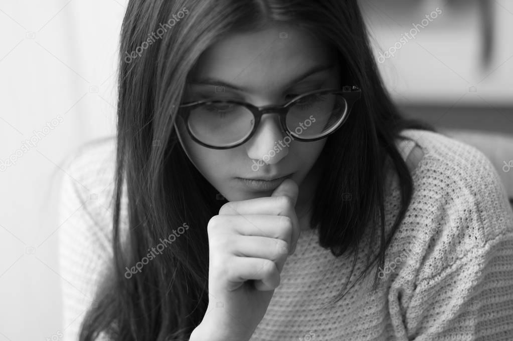 Sad nervous teenage girl with glasses
