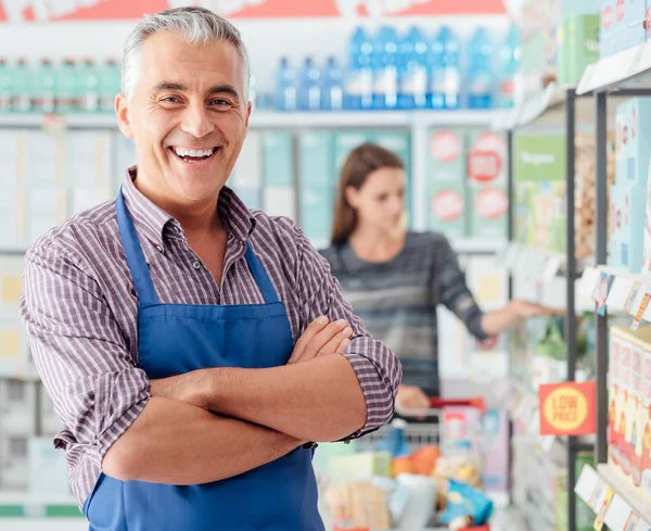 Confident supermarket clerk at shopping mall — Stock Photo, Image