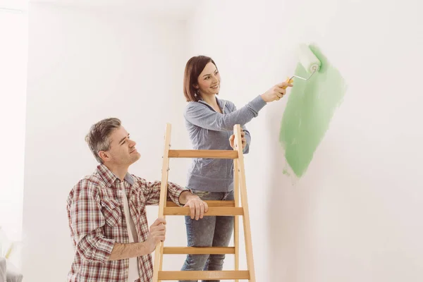 Couple painting walls